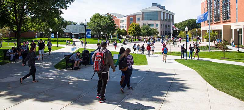 An outdoor scene of students walking between classes at at Southern Connecticut State University