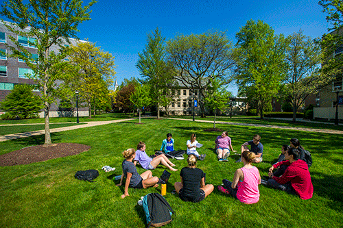 Seton Hall students studying on a lawn on a sunny day.gif